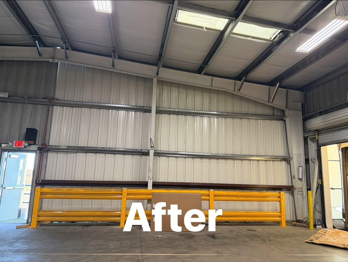 Same warehouse wall and guardrail freshly repainted